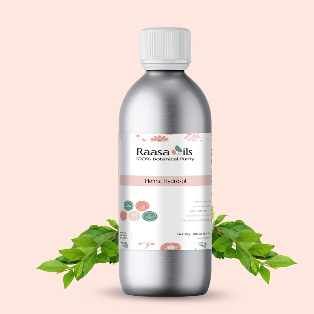 Bottle of Raasa Oils Henna Hydrosol with green leaves on a light pink background