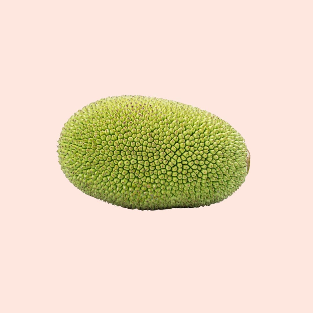 Green jackfruit on a beige background
