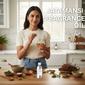 Woman holding a bottle of Jatamansi fragrance oil in a kitchen setting with various ingredients on the table.