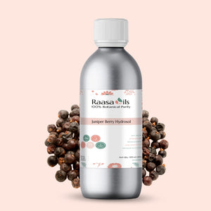 Bottle of Raasa Oils Juniper Berry Hydrosol with juniper berries on a beige background