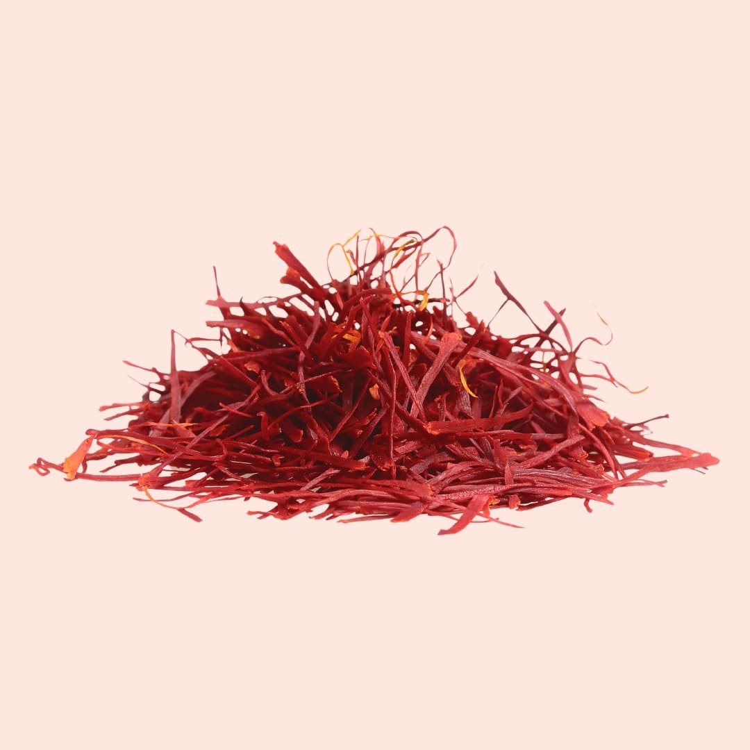 Red saffron threads on a pink background