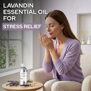 Woman holding a bottle of Lavandin essential oil for stress relief in a home setting.