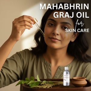 Woman applying Mahabhrin Graj Oil to her face with a dropper, surrounded by natural elements.