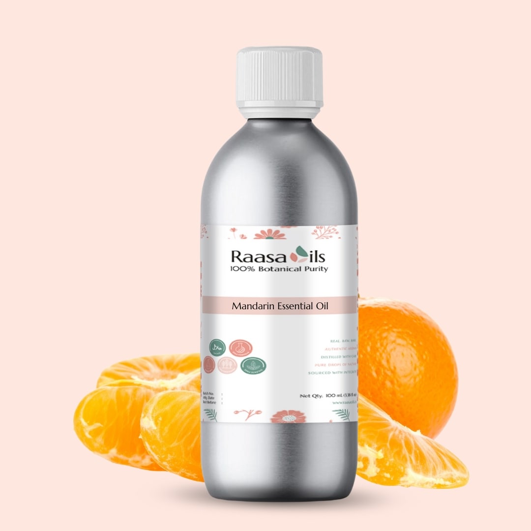 Bottle of Raasa Oils Mandarin Essential Oil with mandarin slices on a light pink background