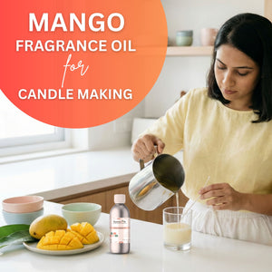 Woman pouring liquid into a glass with mangoes and fragrance oil bottle on a table, text 'Mango Fragrance Oil for Candle Making' on an orange circle.