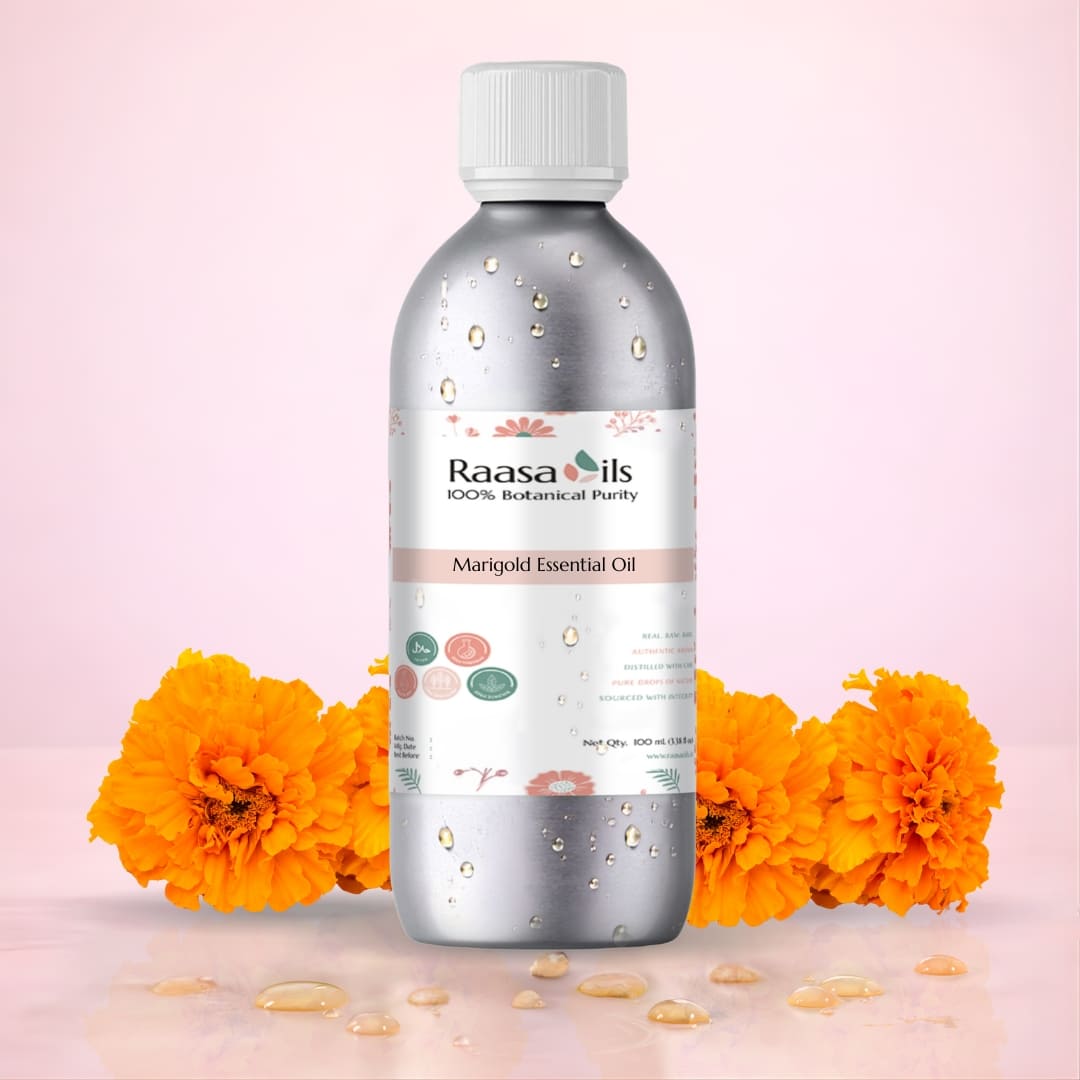 Bottle of Raasa Oils Marigold Essential Oil with marigold flowers on a pink background