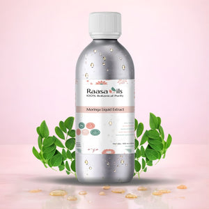 Bottle of Raasa Oils Moringa Liquid Extract with green leaves on a pink background