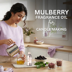 Woman in a kitchen preparing mulberry fragrance oil for candle making.