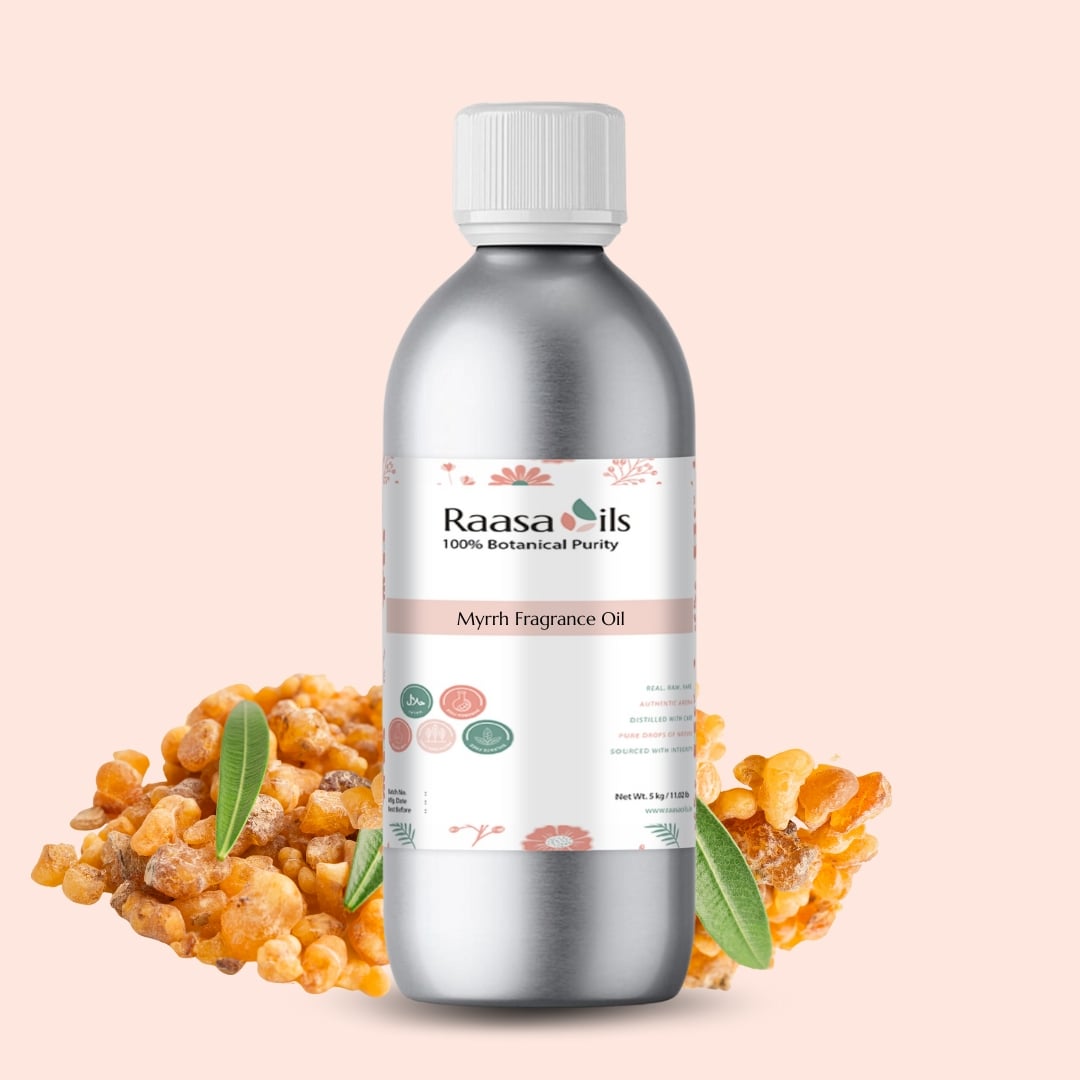 Bottle of Raasa Oils Myrrh Fragrance Oil with myrrh resin and leaves on a beige background