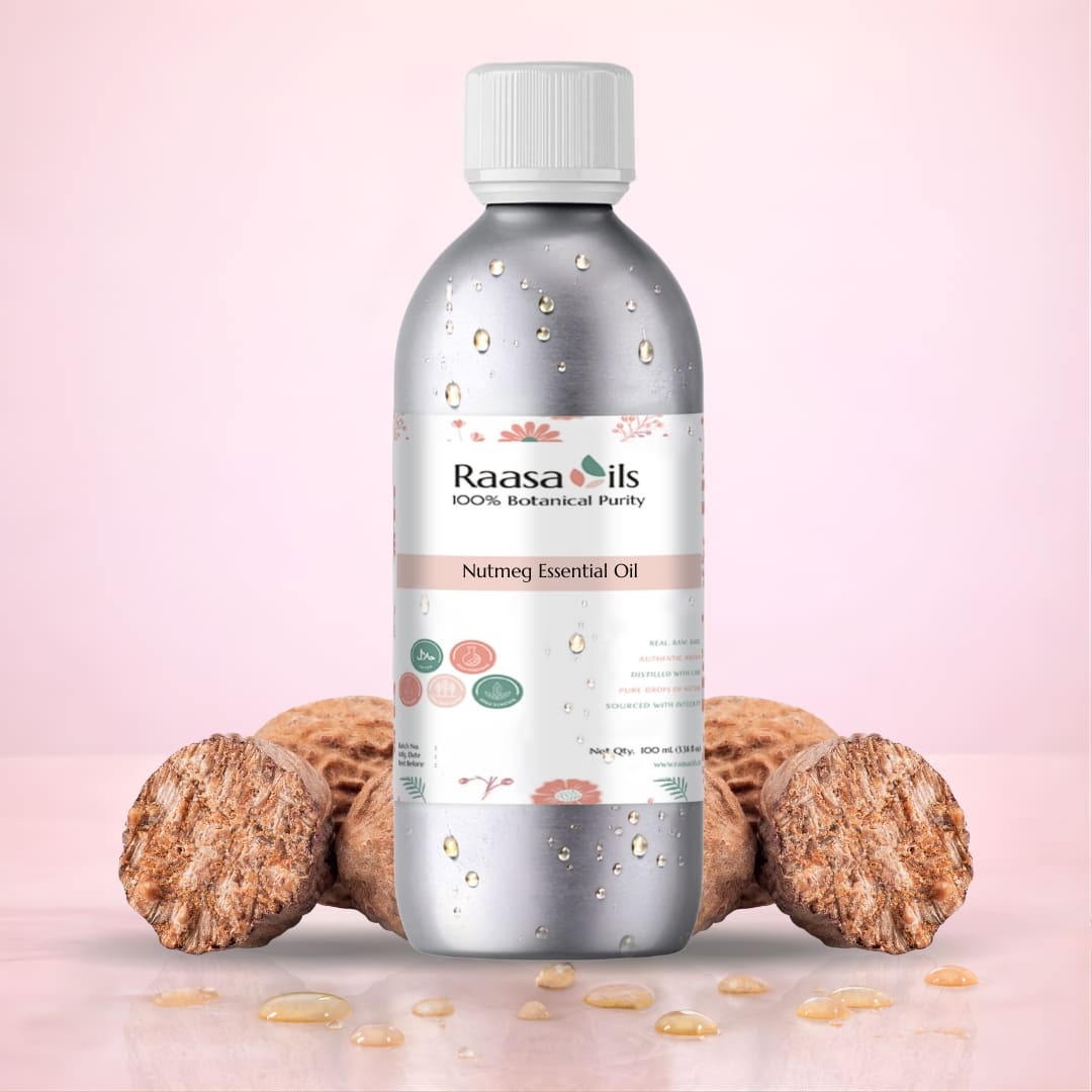 Bottle of Raasa Oils Nutmeg Essential Oil with nutmeg fruits on a pink background