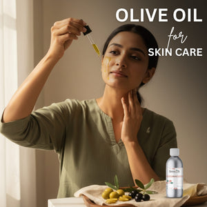 Woman applying olive oil to her face with a dropper, surrounded by olives and a bottle of olive oil.