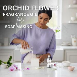 Woman pouring liquid into a soap mold with orchid flowers and fragrance oil bottle on a counter.