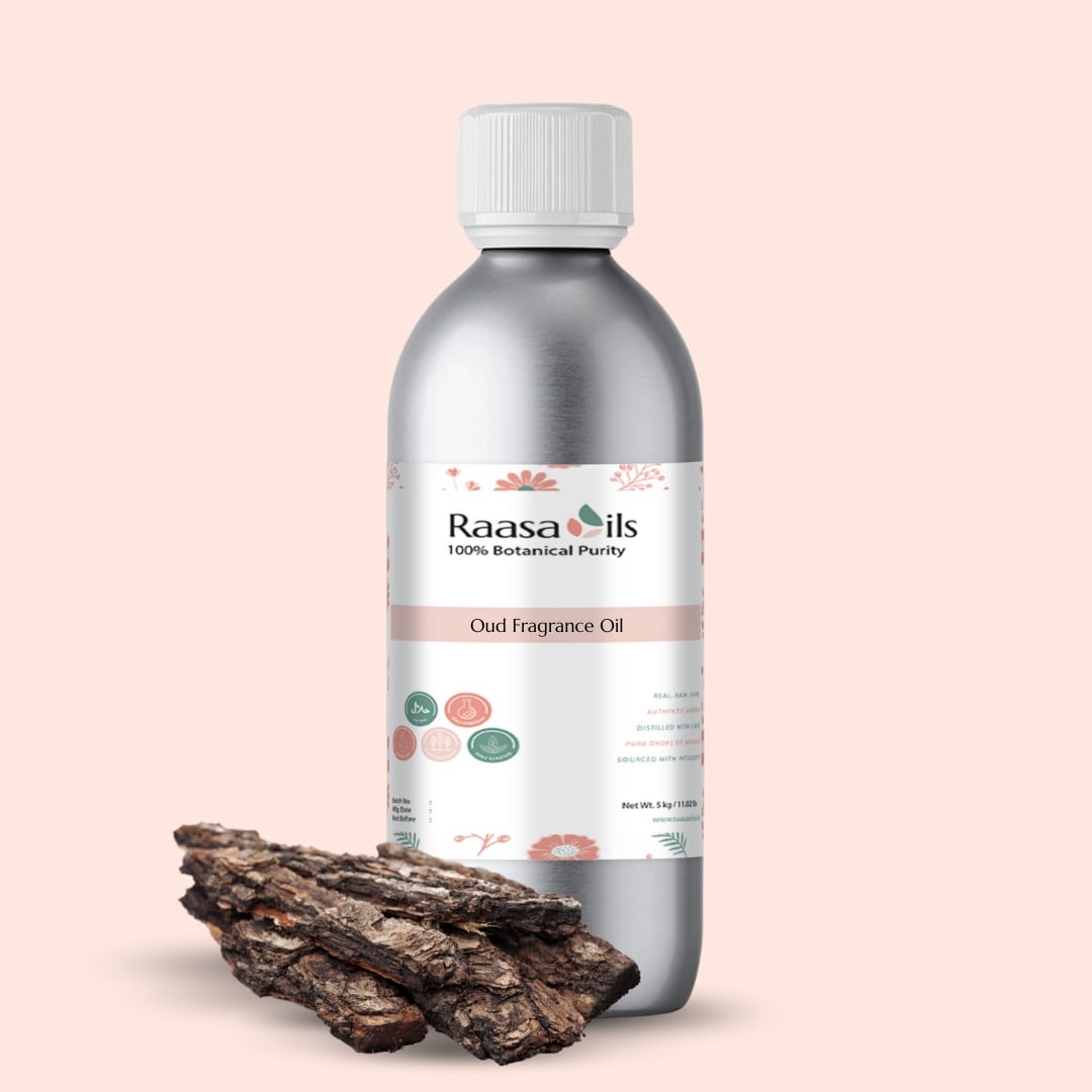 Raasa Oils Oud Fragrance Oil bottle with Oud wood pieces on a beige background