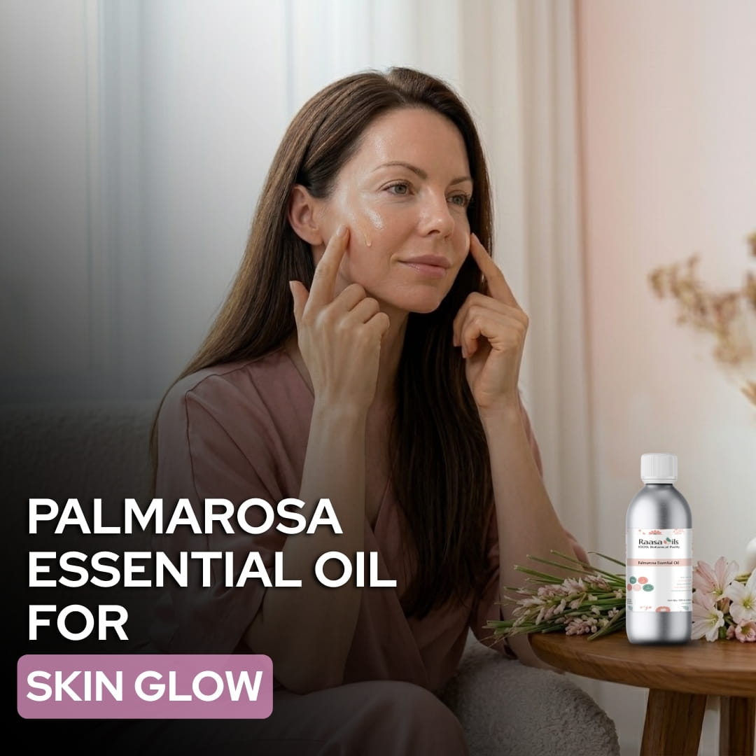 Woman applying Palmarosa essential oil to her face with a bottle of the product on a table.