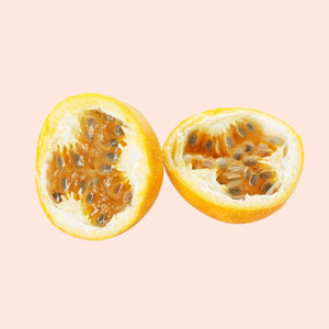 Two halves of a passion fruit on a pink background