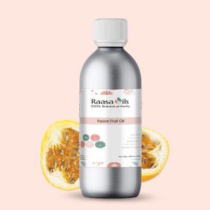 Bottle of Raasa Oils passion fruit oil with a sliced passion fruit on a light pink background