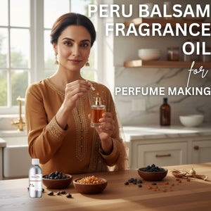 Woman holding a bottle of Peru Balsam fragrance oil in a kitchen setting with ingredients on the table.