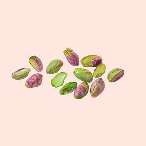 Pistachio shells on a pink background