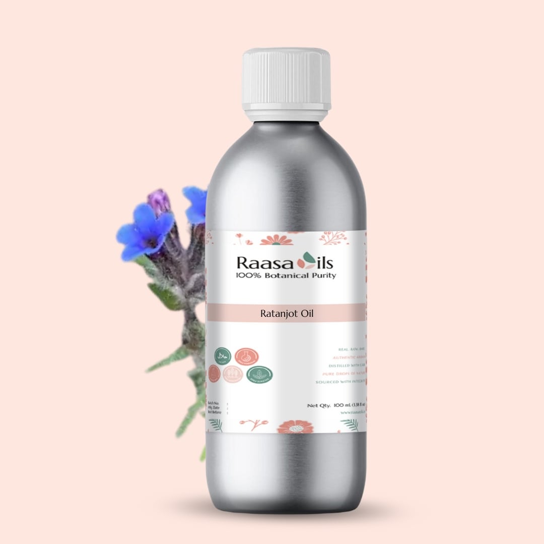 Bottle of Raasa Oils with a label on a light pink background