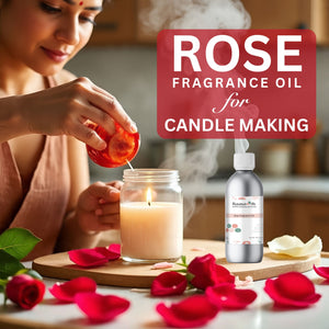 Woman lighting a candle with rose fragrance oil, surrounded by rose petals.