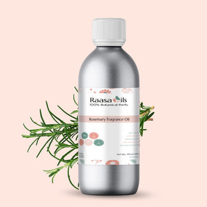 Bottle of Raasa Oils Rosemary Fragrance Oil with rosemary leaves on a light pink background