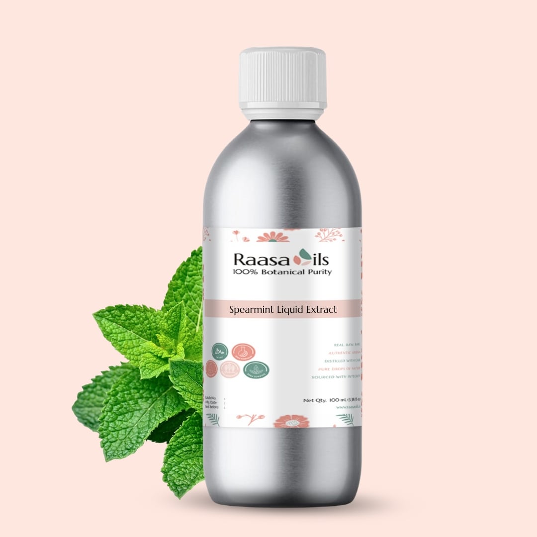 Bottle of Raasa Oils Spearmint Liquid Extract with mint leaves on a light pink background
