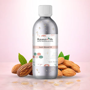 Bottle of Raasa Oils Sweet Almond Oil with almonds and leaves on a pink background