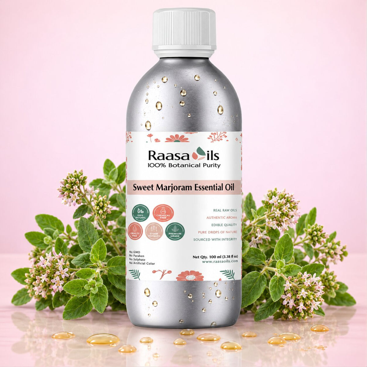 A bottle of Raasa oils Sweet Marjoram Essential Oil centered on a pink background, flanked by green marjoram leaves and small white flowers, with golden oil droplets scattered around the base.