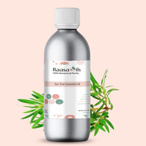Bottle of Raasa Oils Tea Tree Essential Oil with a pink background and green leaves.