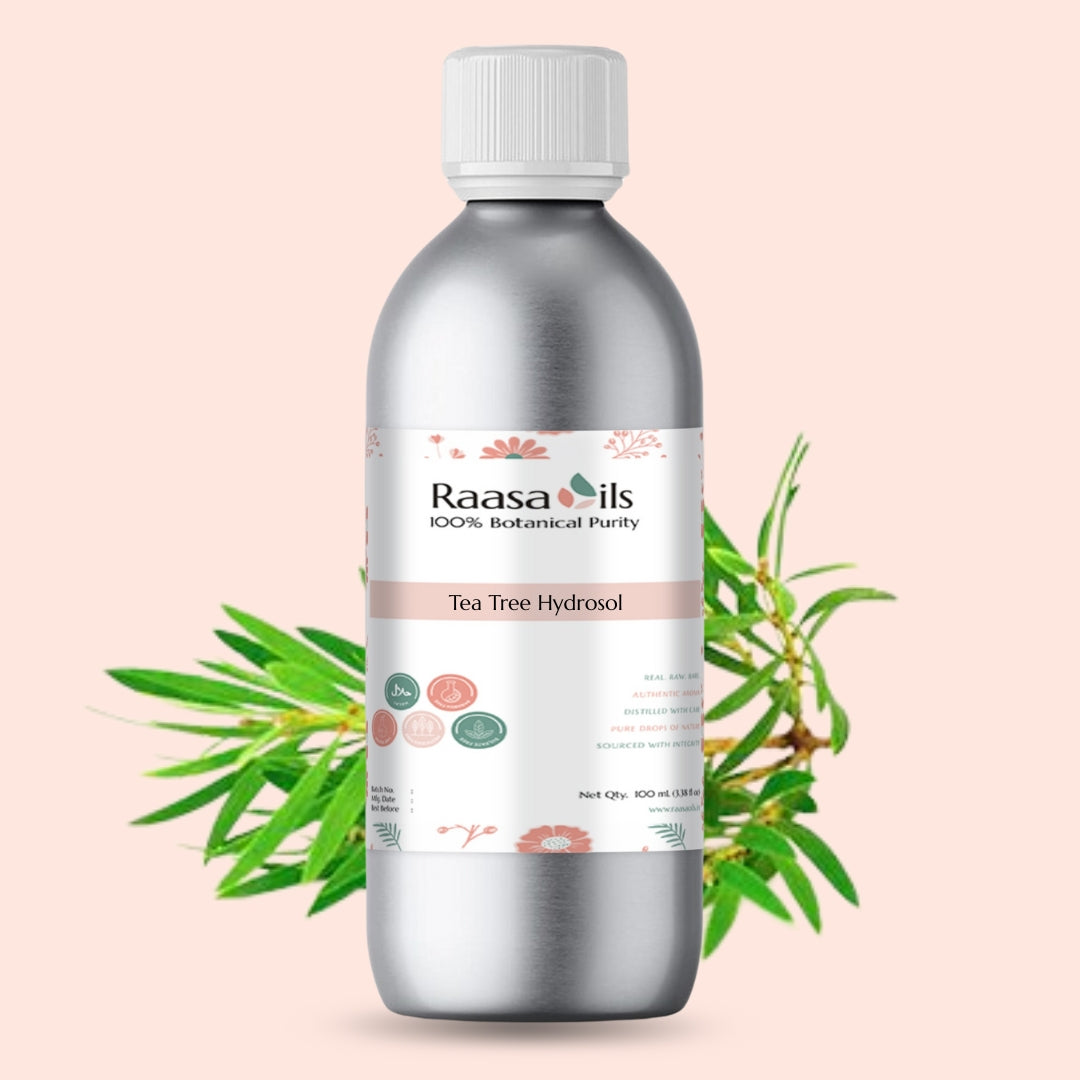 Bottle of Raasa Oils Tea Tree Hydrosol with tea tree leaves on a light pink background