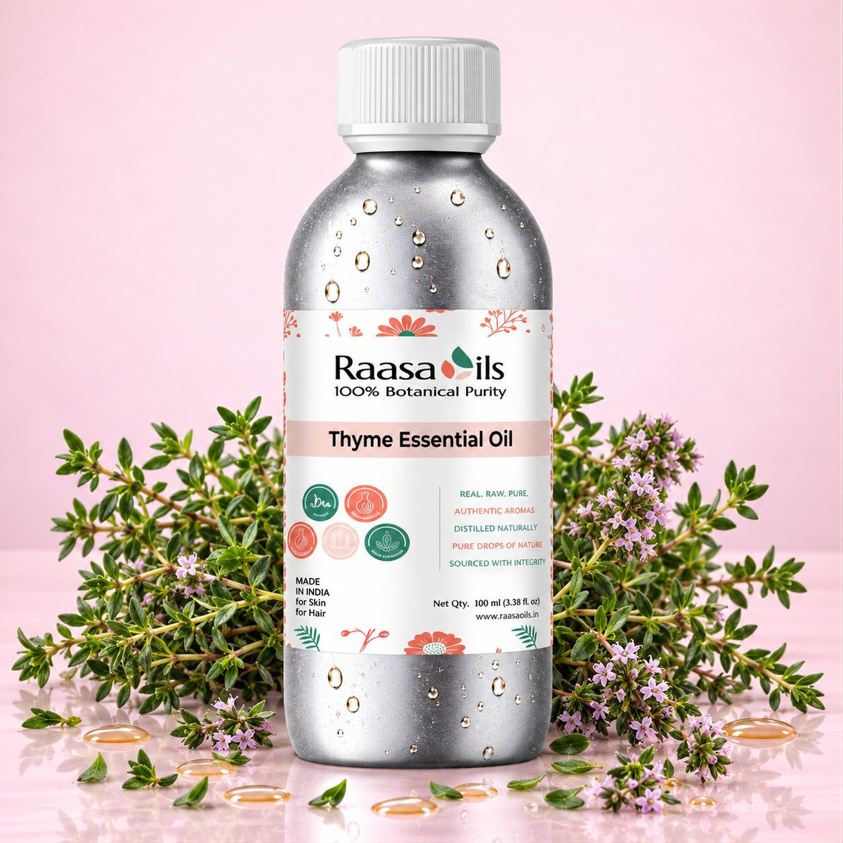 A bottle of Raasa oils Thyme Essential Oil centered on a pink background, surrounded by fresh thyme sprigs, flowers, and scattered gold droplets. The bottle is metallic silver with a white cap and a white label featuring pink, green, and orange accents.
