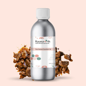 Bottle of Raasa Oils Tolu Balsam Essential Oil with balsam pieces on a beige background