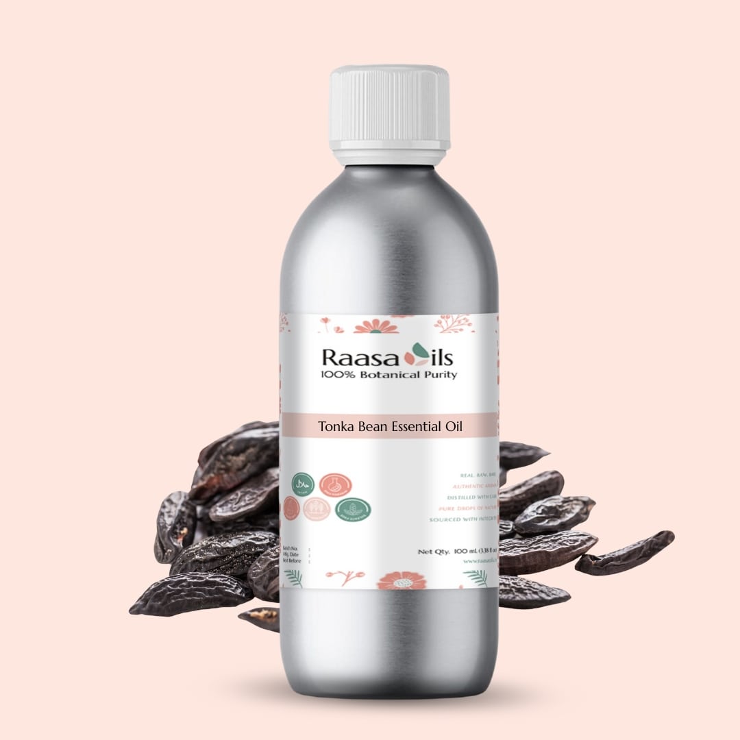 Bottle of Raasa Oils Tonka Bean Essential Oil with tonka beans on a light pink background