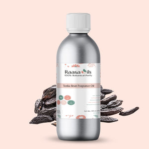 Bottle of Raasa Oils Tonka Bean Fragrance Oil with tonka beans on a light pink background