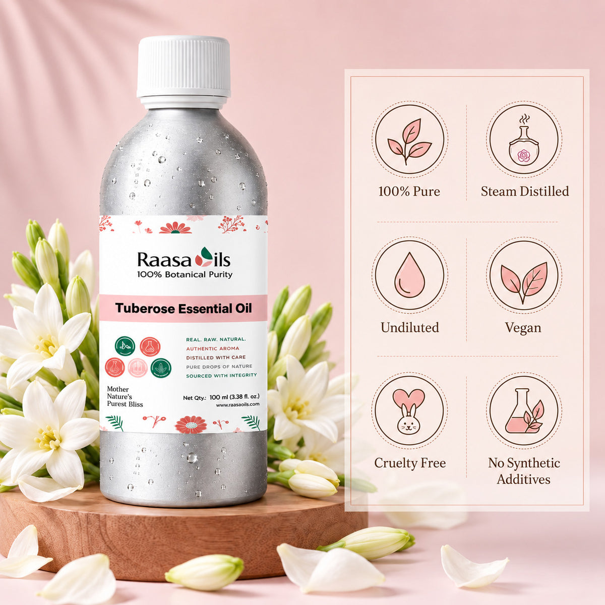 A bottle of Raasa Oils Tuberose Essential Oil stands on a wooden surface with white flowers around it against a soft pink backdrop. A product information panel with icons and text appears to the right, showing claims like 100% Pure, Steam Distilled, Undiluted, Vegan, Cruelty Free, and No Synthetic Additives.
