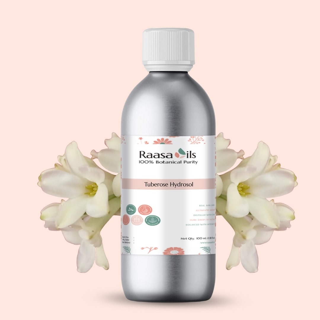 Bottle of Raasa Oils Tuberose Hydroal on a light pink background with white flowers.