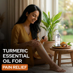 Woman applying turmeric essential oil to her leg with a bottle of oil on a small table.