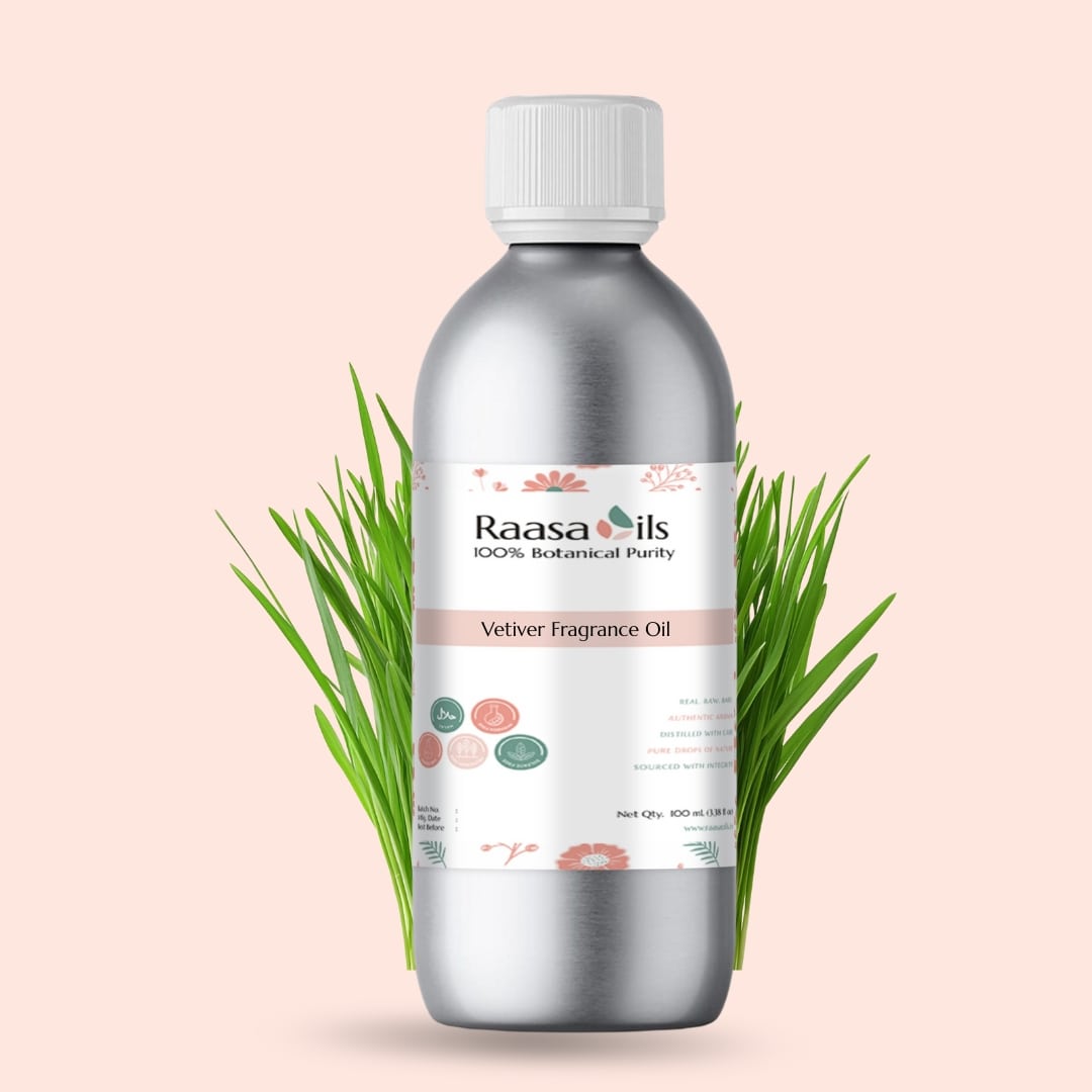 Bottle of Raasa Oils Vetiver Fragrance Oil with green leaves on a light pink background