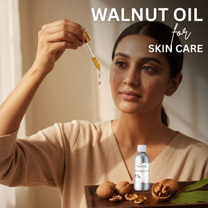 Woman holding a dropper with walnut oil over her face, surrounded by walnuts and a bottle of walnut oil on a wooden tray.