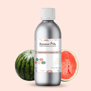 Bottle of Raasa Oils watermelon fragrance oil with a watermelon on a beige background