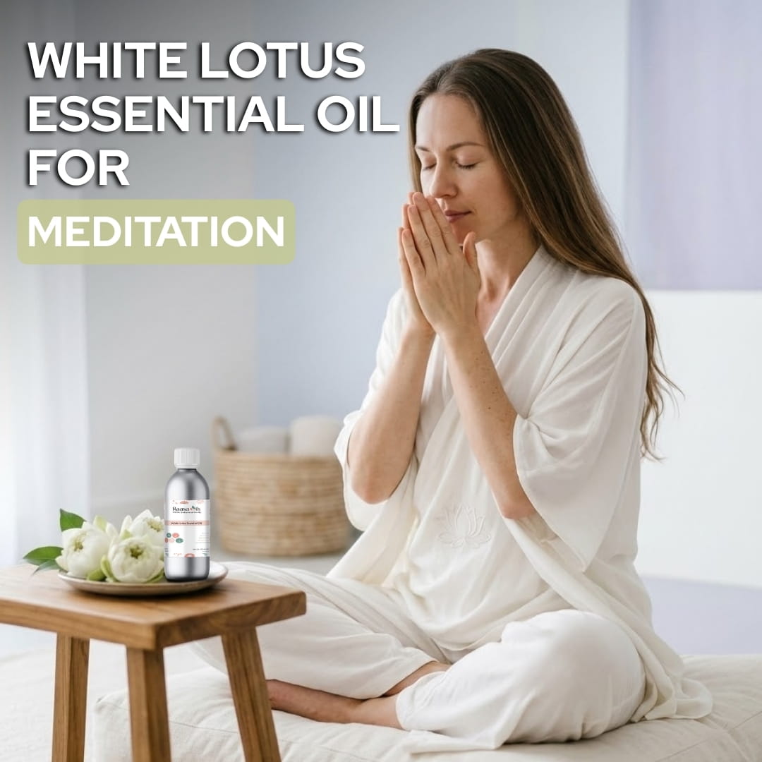 Woman meditating with a bottle of White Lotus essential oil on a table.