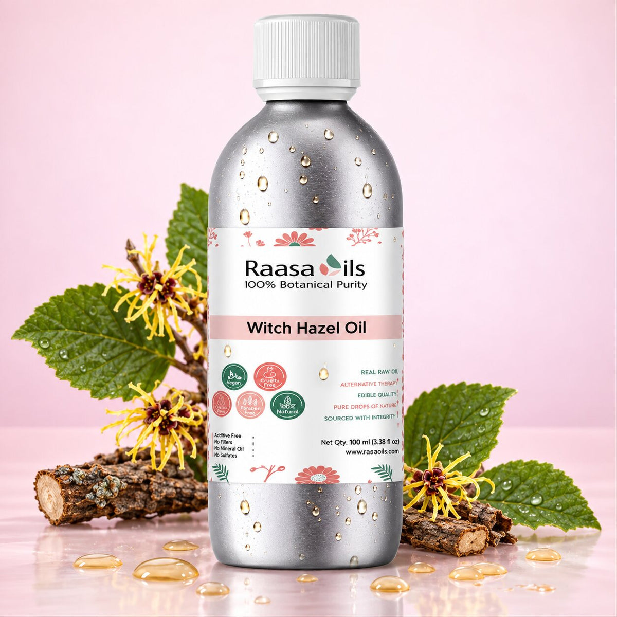A bottle of Raasa Oils Witch Hazel Oil centered on a pink background, surrounded by witch hazel flowers, green leaves, and small drops of oil on a reflective surface.