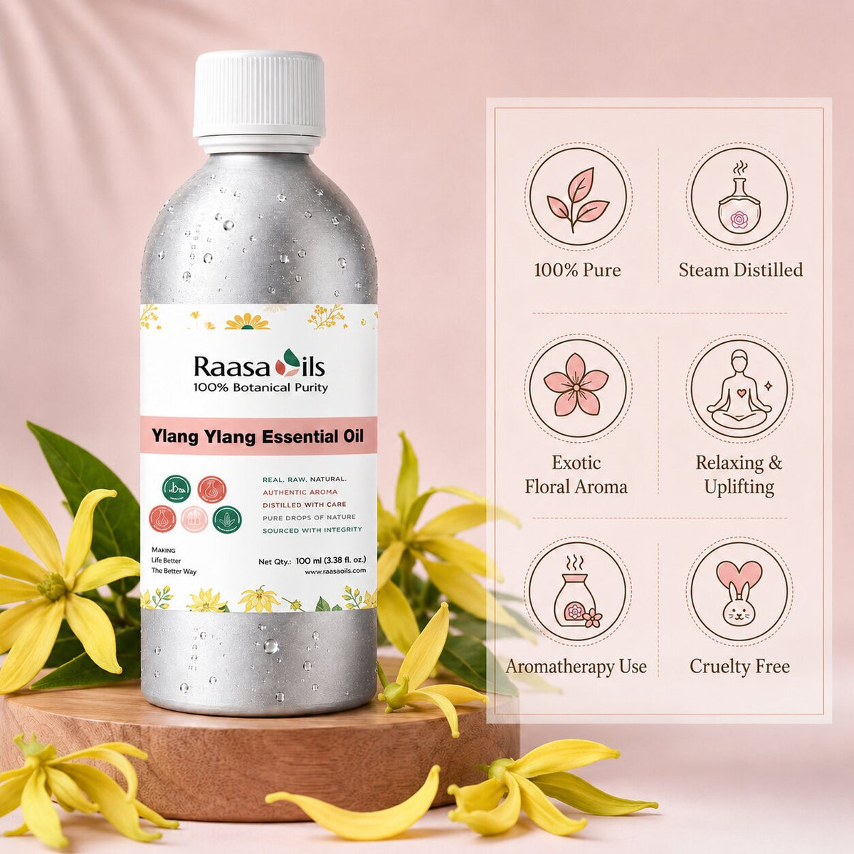 A bottle of Raasa Oils Yang Yang Essential Oil stands on a wooden tray with yellow flowers around it against a soft pink backdrop. A product information panel on the right lists benefits such as 100% pure, steam distilled, exotic floral aroma, relaxing and uplifting, anomatherapy use, and cruelty free.